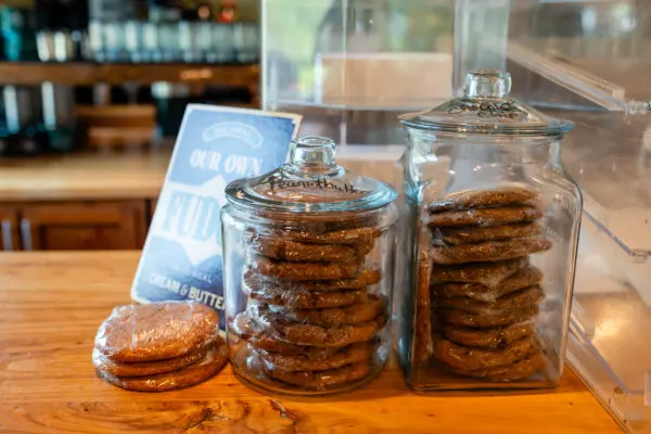 A table with two jars of cookies on it