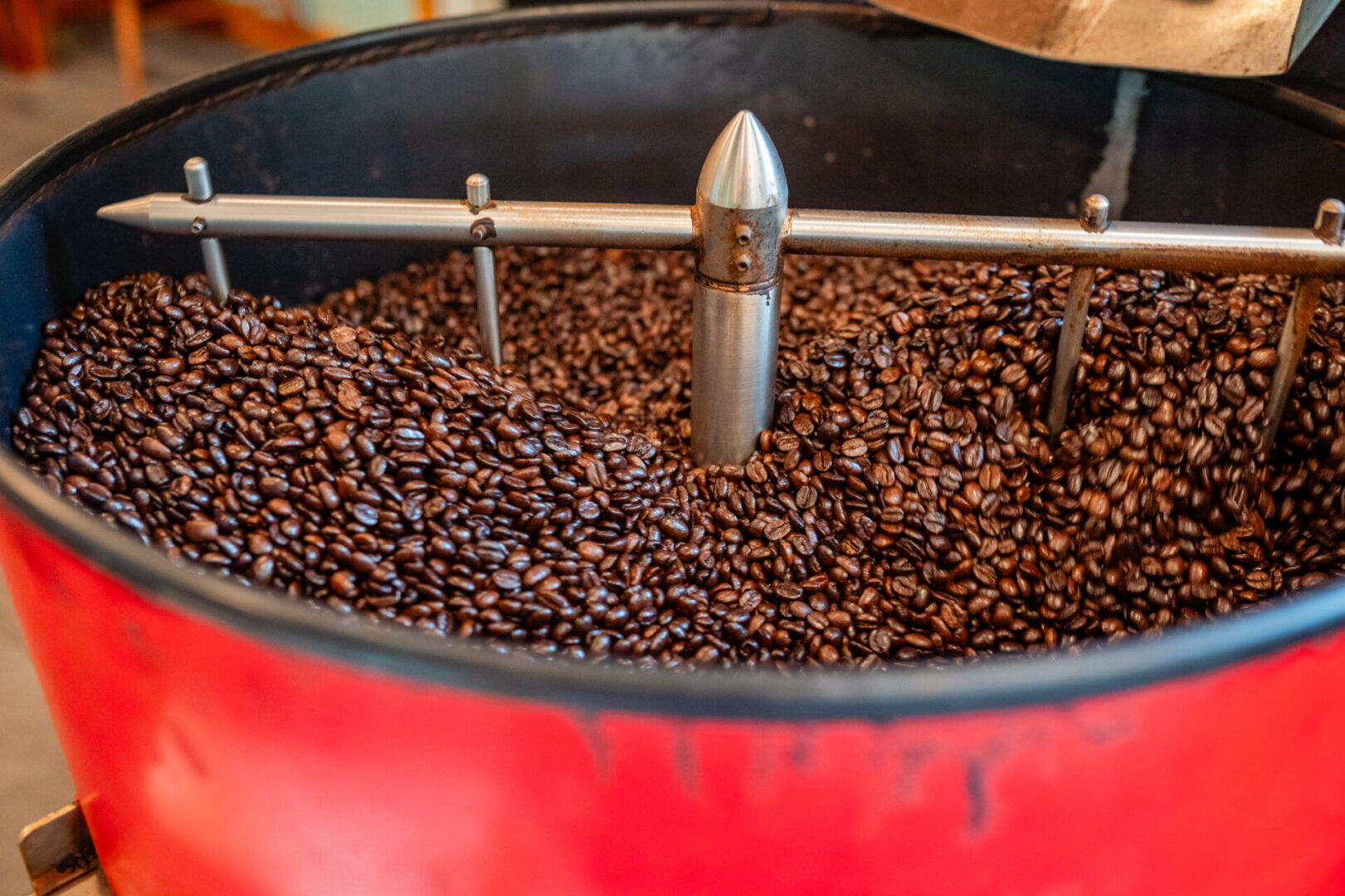 A red barrel filled with coffee beans.